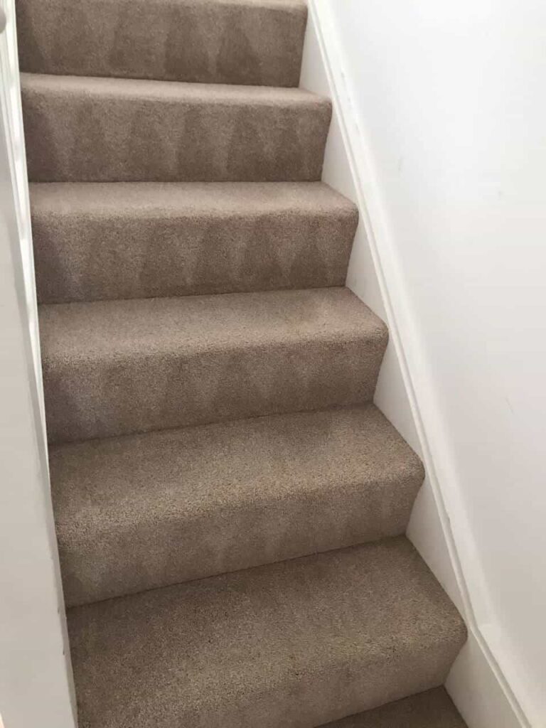 This is an after photo of a staircase with a beige carpet that has been cleaned works carried out by Penge Carpet Cleaning