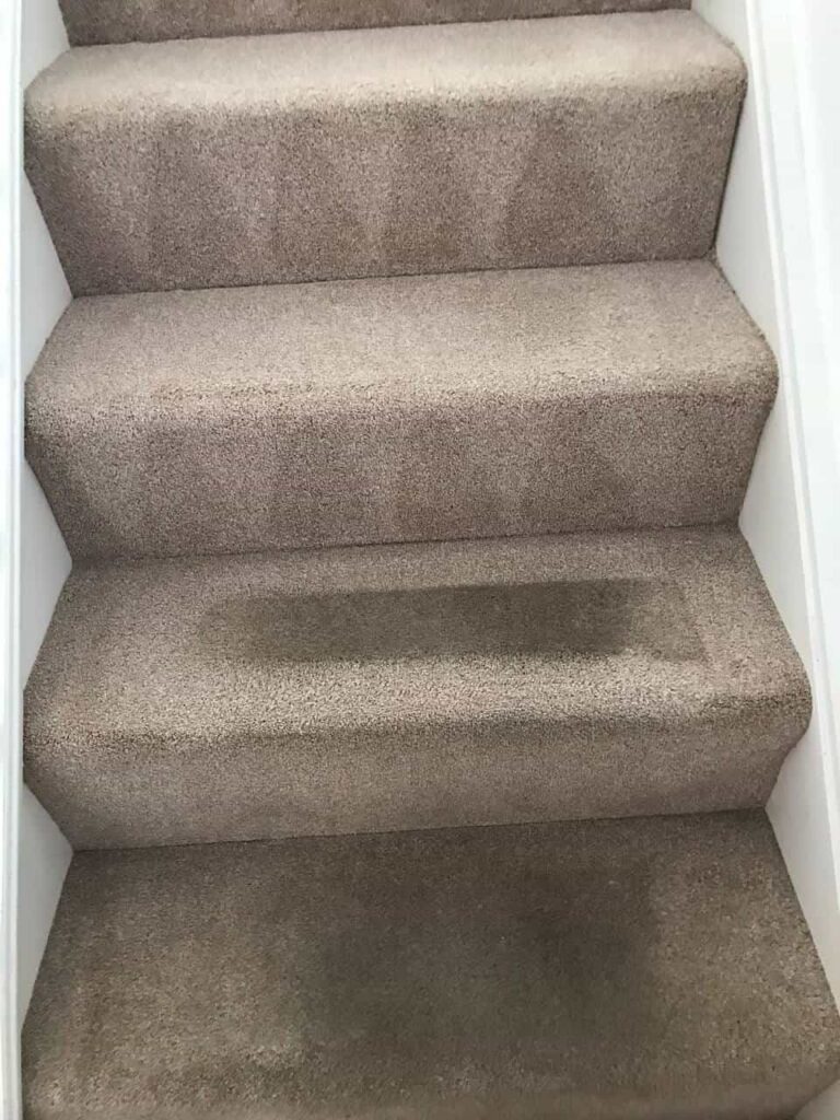 this is a photo of a staircase with beige carpets that is in the process of being cleaned works carried out by Penge Carpet Cleaning
